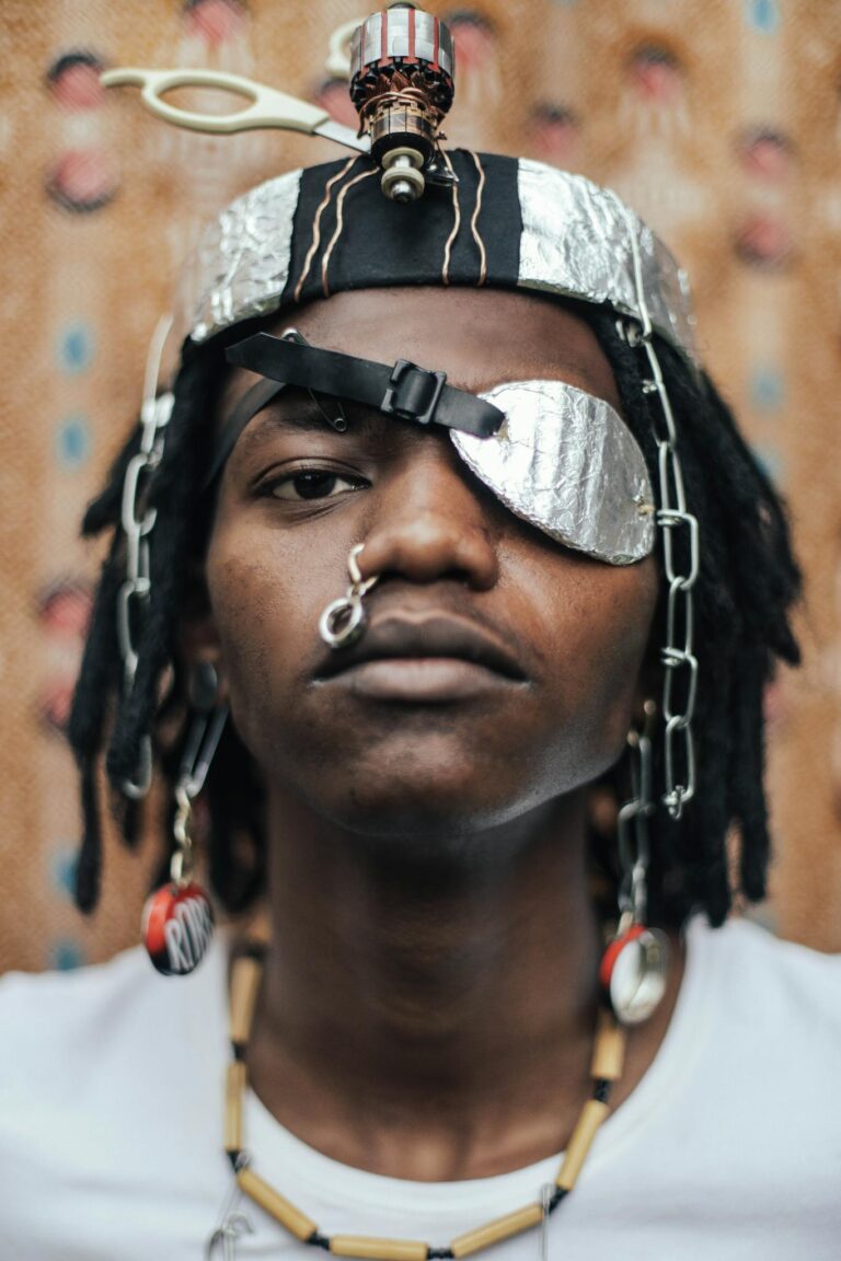 A striking portrait of a man with bold accessories and artistic expression, highlighting modern fashion creativity.